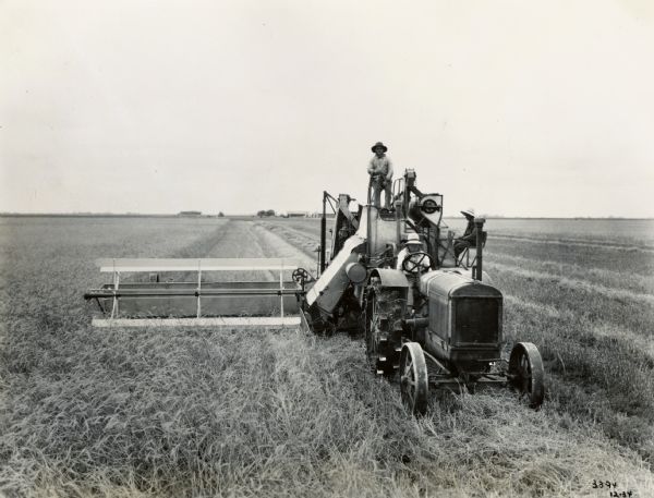 Three men operating an International 15-30 tractor and a No. 31 harvester-thresher (combine), cutting wheat in a 12-foot swath in Argentina.