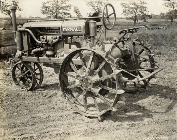 Farmall Regular tractor parked near a field.