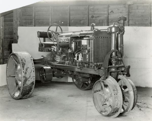Engineering photograph of a Farmall F-20 tractor with industrial seat and front extension rims.