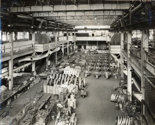 Elevated view of tractors, engines and parts on the floor of International Harvester's Milwaukee Works (factory).