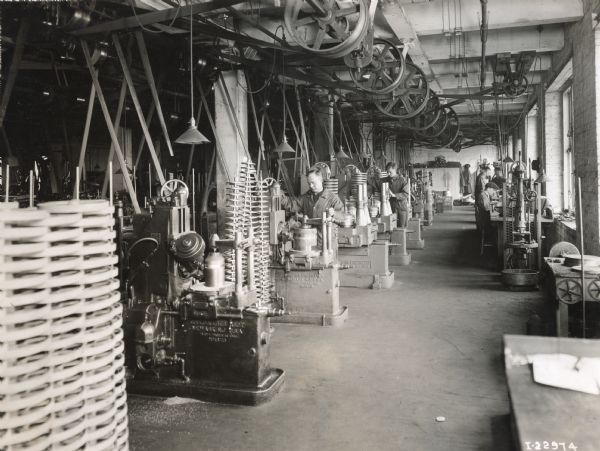 Factory workers at their stations at International Harvester's Milwaukee Works (factory).