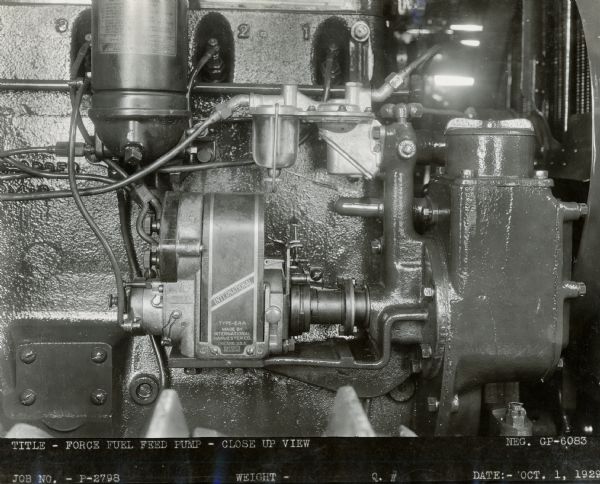 Engineering photograph of a "force fuel feed pump" on a tractor engine.