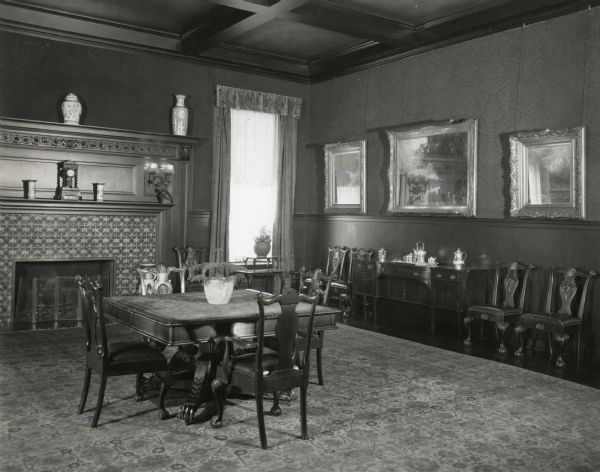 The southeast corner of the dining room at Cyrus McCormick, Jr.'s residence at 50 East Huron Street. According to the original caption, the paintings on the south wall are, from left to right: "The Two Trees" by Chas. Emile Jacques [?]; "Lake hemi"[?] by Jean Baptiste Corot; and marine (not listed in quotation marks), by Jules Dupre.