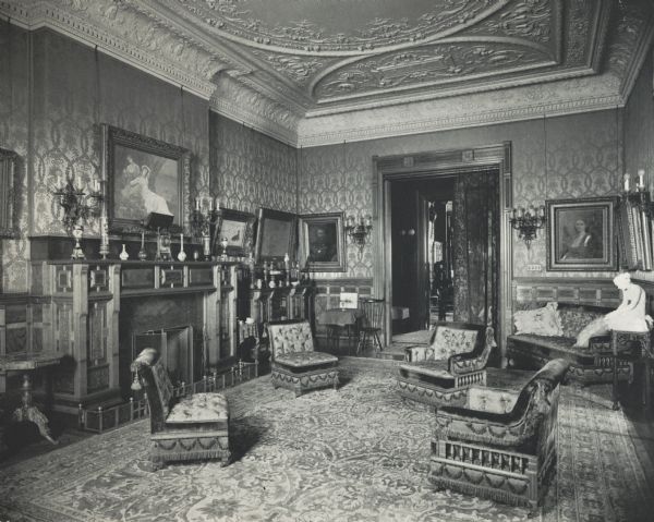 Ornately decorated room with fireplace at 675 Rush Street. The house was built for Cyrus Hall McCormick and his family in 1879. After McCormick's death in 1884, the house was occupied by his widow Nettie Fowler McCormick. The photograph is taken from a photograph album entitled: "The Old Home".