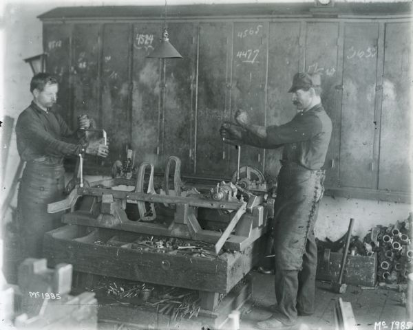 Factory workers assembling a machine at International Harvester's McCormick Works.