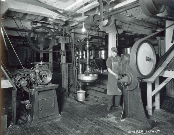 Factory worker machining(?) parts at International Harvester's Osborne Works (later known as "Auburn Works").