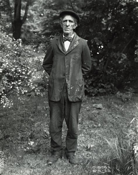 An Osborne Works factory worker(?) standing outdoors to have his portrait taken.