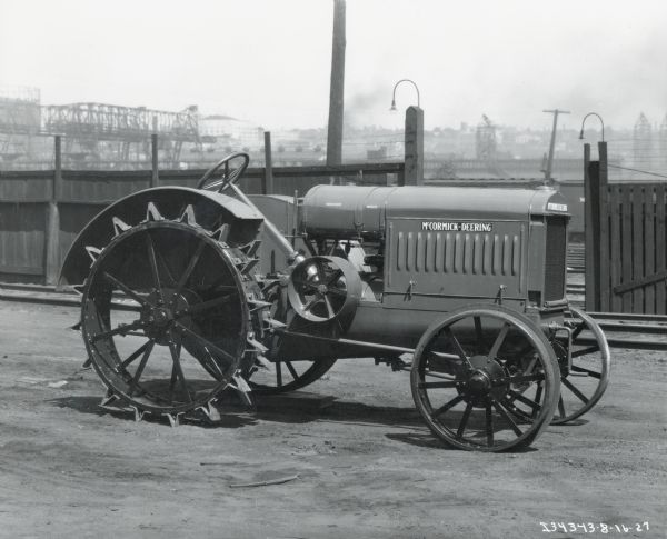 Right side view of a McCormick-Deering 15-30 tractor parked in an industrial area, probably near an International Harvester factory.
