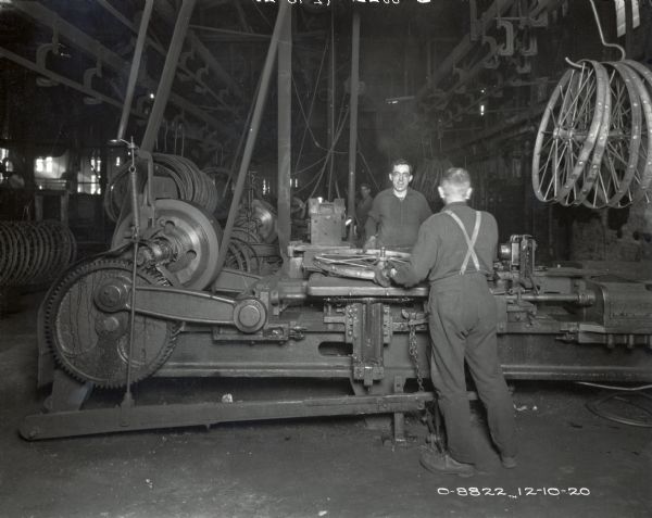 Factory workers produce wheels for farm implements at International Harvester's Osborne Works (later known as Auburn Works.