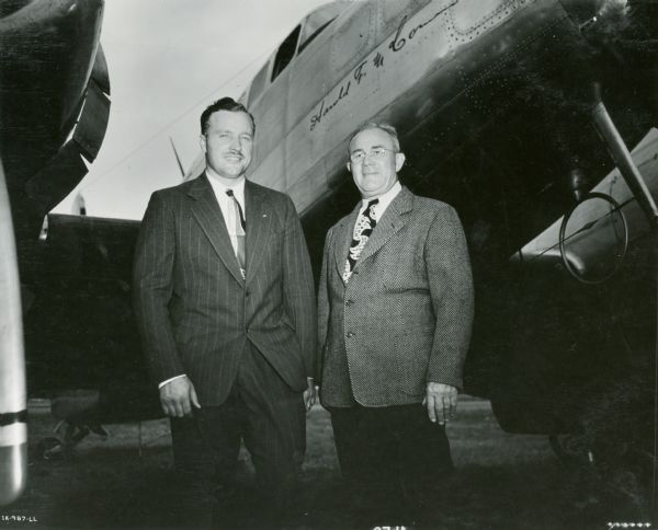 Pilot William R. Dotter and Co-Pilot Walter Daiber standing next to the "Harold F. McCormick", an International Harvester corporate airplane.