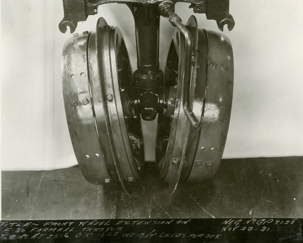Engineering photograph of a front wheel extension on a Farmall F-30 tractor.