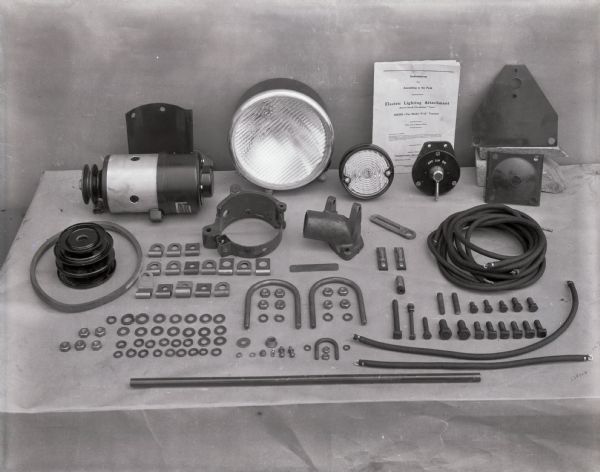 Parts for an electric lighting attachment (Robert Bosch "No-Battery" Type) for a Farmall tractor.
