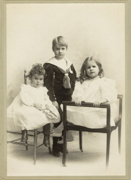 Portrait of young Gordon, Cyrus III, and Elizabeth, the children of Cyrus McCormick Jr.  Cyrus III is wearing a sailor suit, while Elizabeth and Gordon wear white dresses.