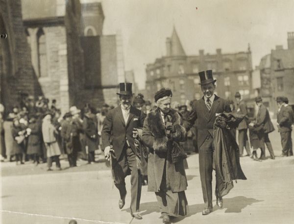 Photograph taken by a reporter on Easter Sunday, of Nettie Fowler McCormick (1835-1923) leaving Fourth Church in Chicago with her great-nephew, Chauncey Brooks McCormick (1884-1954), and her grandson Harold Fowler McCormick Jr., (1898-1972). They are all in formal attire.