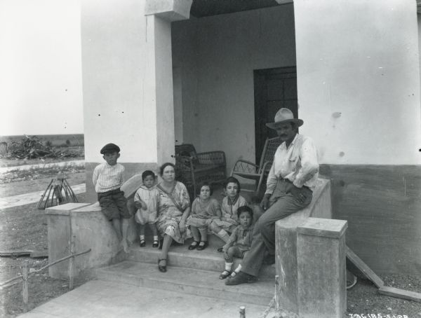 Diomicio Saeng, the manager of Haciend El Tejon (76 miles Southwest of Metamoras, Mexico), posing with his five children and wife on the steps of their home.