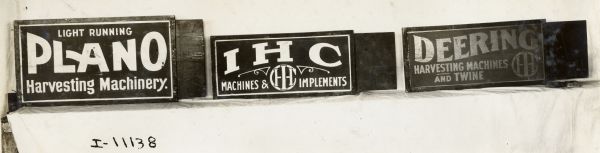 Series of three International Harvester advertising signs: Light Running Plano Harvesting Machinery; IHC Machines & Implements; Deering Harvester Machines and Twine.