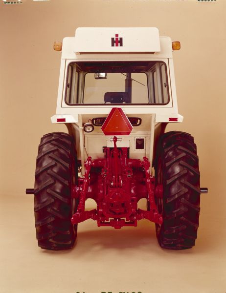 Color studio shot of back of the Farmall 1066 tractor with cab.