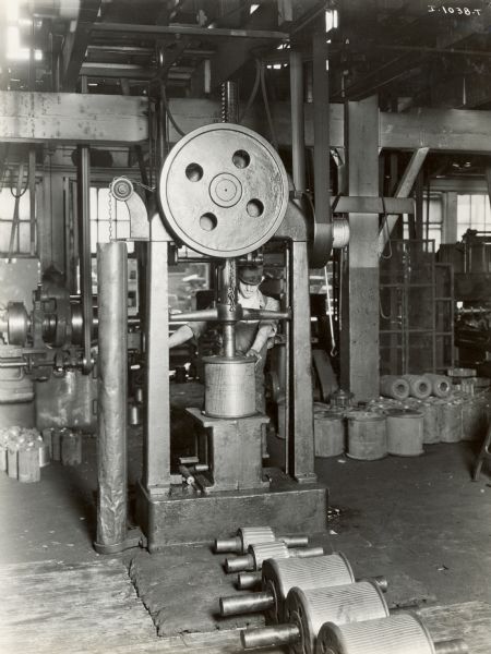 Factory worker using a press at the Chattanooga Plow Works.