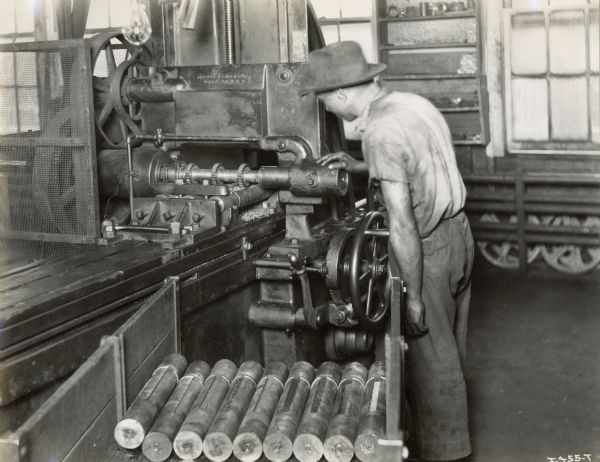 A factory worker at the Chattanooga Plow Works operating a machine.