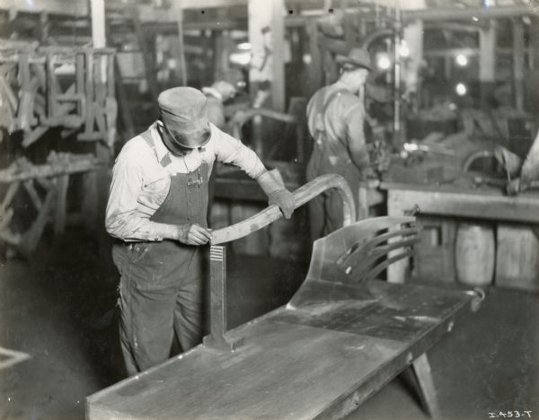 Factory workers assemble plows at the Chattanooga Plow Works.