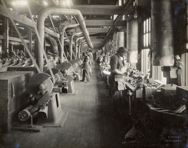 Factory workers at machines in the Chattanooga Plow Works.