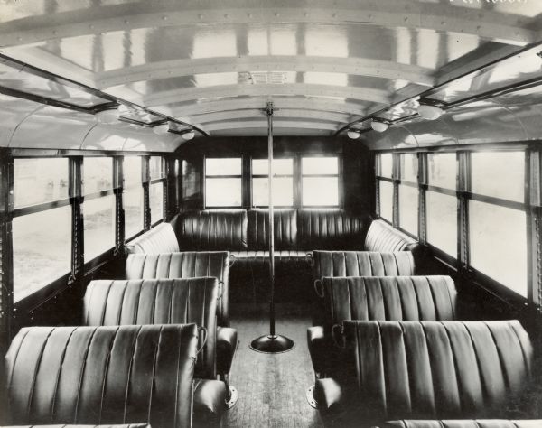 The interior of an International motor coach, or bus, showing leather seats and a spacious center aisle. The bus was built on a model 52 or model 53 chassis.