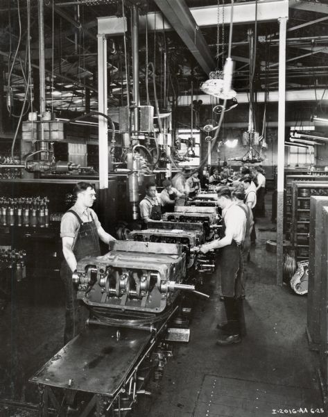 Factory workers running a diesel engine assembly line at Milwaukee Works.