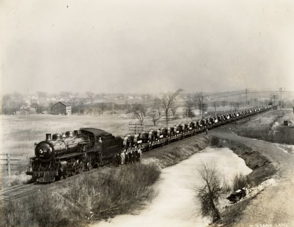 A train carrying tractors stopped on its way from Milwaukee Works (factory).