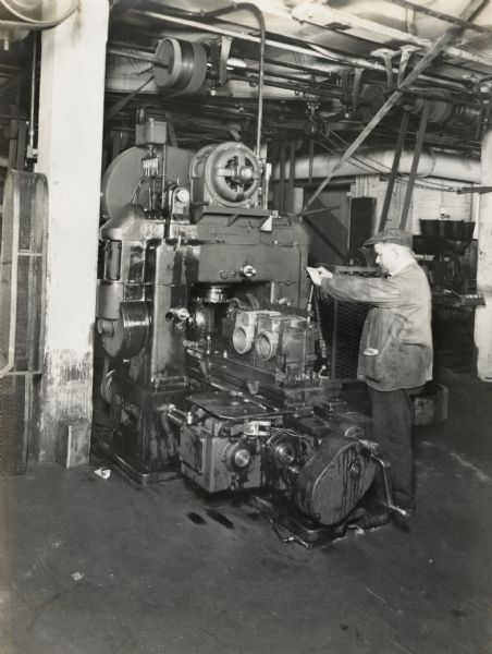 Factory worker operating a machine at Milwaukee Works.
