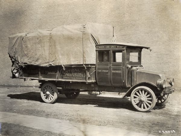International Model G-61 truck being used for the "Long Distance Hauling [of] Central Storage Warehouse, Where Care Saves Wear."