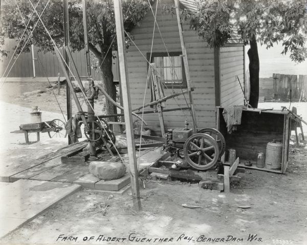 View of what appears to be a water pump powered by an International Harvester stationary engine on the farm of Albert Guenther.
