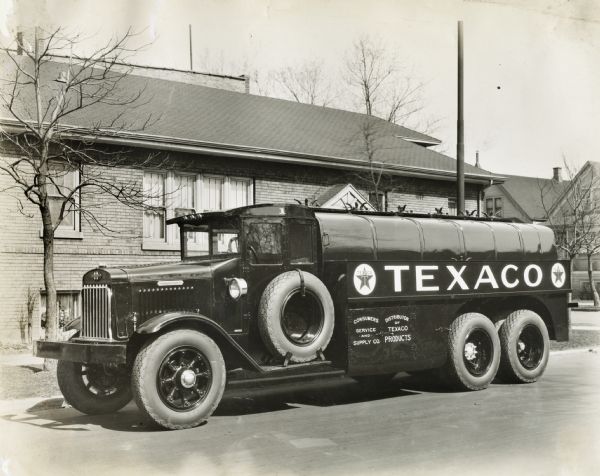 International Texaco truck parked alongside a curb.