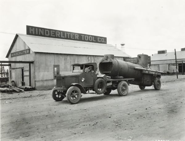 An International Model "63"(?) oil truck parked in front of the Hinterliter Tool Co.