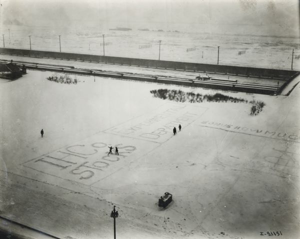 Elevated view from a window of the International Harvester offices on Michigan Avenue showing Grant Park. Company employees have written their department names in the snow. Names include "IHCo. Stocks" and "Experimental Department."