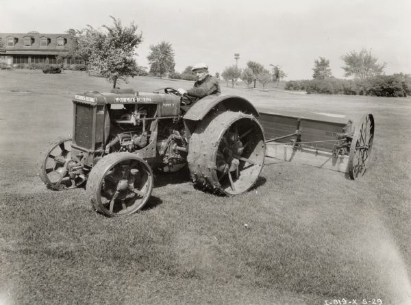 Ralph Teter, groundskeeper of the Aurora Country Club, sits on a McCormick-Deering Fairway 12 tractor.
