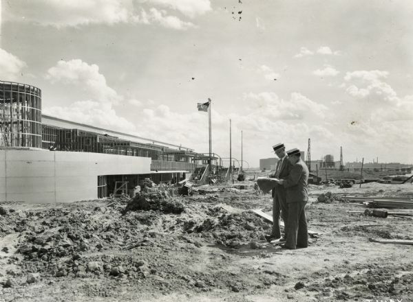 Two men stand at the construction site for International Harvester's exhibit building at the "A Century of Progress" world's fair in Chicago.
