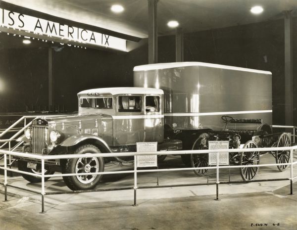 International A-8 model truck with a Fruehauf semi-trailer van and a 1907 International auto wagon on display at the "A Century of Progress" world's fair.