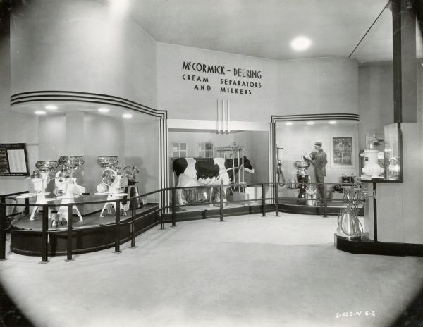 Cream separators, milkers and a mechanical cow on display in the International Harvester exhibit at the "A Century of Progress" world's fair. Caption in "The Harvester World" reads: "Lady Alken Ina Ormsby received the adulation of multitudes who counted their visit to A Century of Progress complete only after seeing her and hearing her moo."