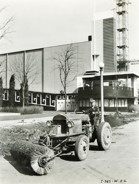 An International industrial tractor with a street sweeping attachment sweeping the roads at the "A Century of Progress" world's fair.