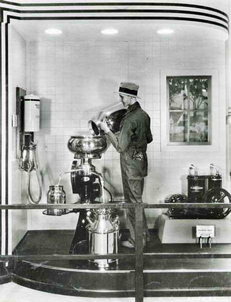A cream separator and power unit milker with mannequin on display in the International Harvester exhibit at the "A Century of Progress" world's fair.