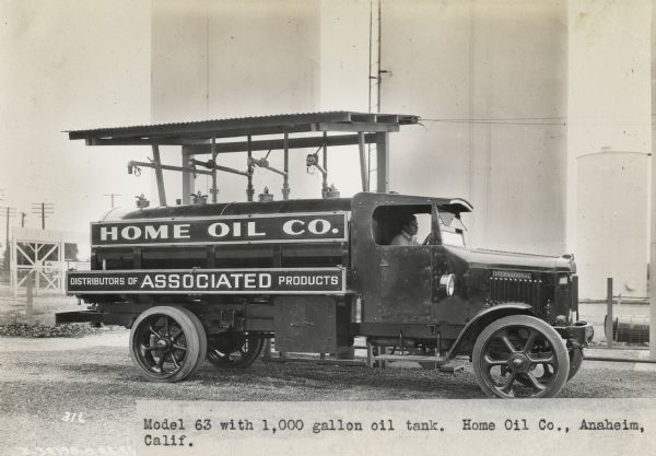 International Model 63 truck parked at an oil pump. The truck has a 1,000 gallon oil tank for the Home Oil Company "Distributors of Associated Products" of Anaheim, California.