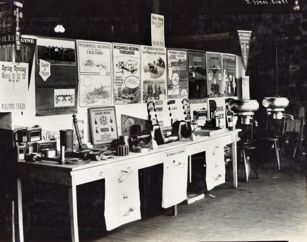 Various machinery parts, cream separators and advertising posters on display at what is possibly the "Spring Opening" of the Walton & Sykes dealership.