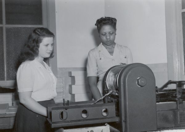 Two female factory workers at International Harvester's Tractor Works.