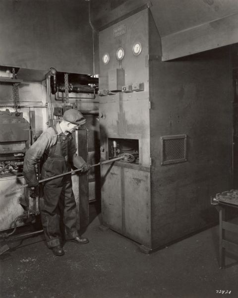 Factory worker operating a "Hannifin quenching press" at International Harvester's Milwaukee Works.