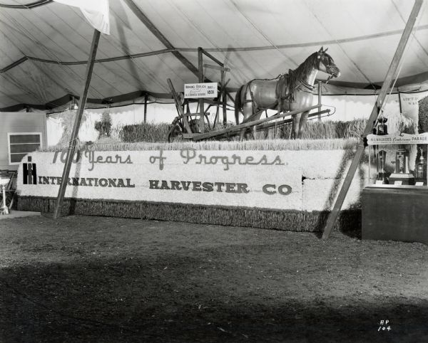 International Harvester reaper float, the first prize winner in the Wisconsin State Fair dairy parade. The text on the float reads: "Working Replica of the Original McCormick Reaper; Built in 1831" and "100 Years of Progress; International Harvester Co." The dairy parade took place on Friday, August 23.