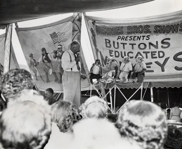 An audience gathers to watch the "Buttons Educated Monkeys" show, one of the attractions televised to the International Harvester tent at the Iowa State Fair.