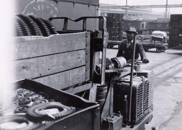 Factory worker Horace Holmes uses a forklift to move parts at International Harvester's Tractor Works.