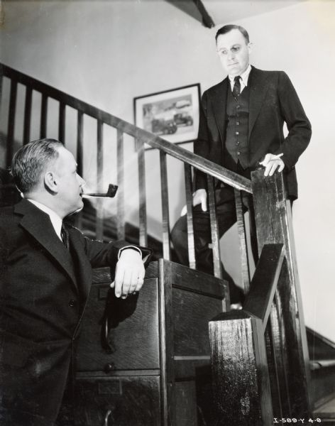 Mercer Lee, branch manager of the Atlanta trucks sales organization, looks down at J.N. Martin, motor truck sales manager, from a flight of stairs.