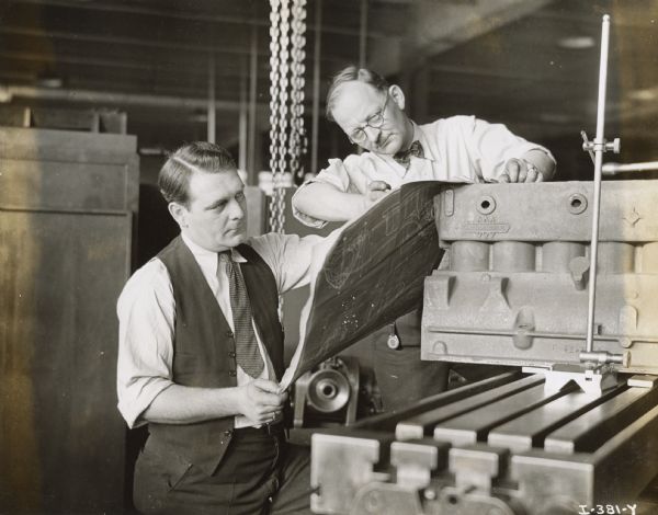 John Seltzer (left) and T.C. Phillips examine a blueprint in the Engineering Department of International Harvester's Fort Wayne Works.