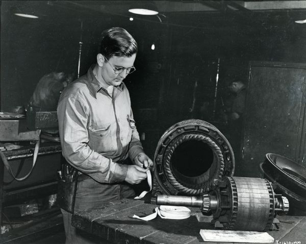 An electrical apprentice repairs an electric motor at McCormick Works.